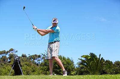Buy stock photo Senior, man and playing golf on green grass, lawn or field for sports, swing or taking a shot on course. Mature male person, golfer or player hitting ball or strike for goal, score or point in nature