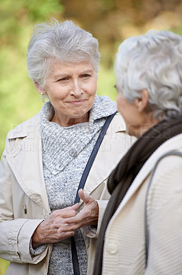 Buy stock photo Senior women, listening and conversation in park together for social, morning and bonding on retirement in outdoor. Elderly friends, smile and talking of pension in england, care and calm in nature