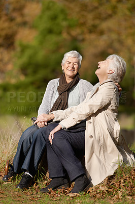 Buy stock photo Senior friends, laughing or conversation in nature for travel, together or bonding on retirement in outdoor. Elderly women, smile or communication on vacation in countryside, care or comic on rock