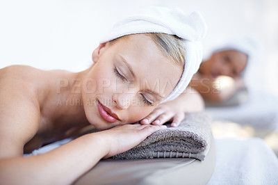 Buy stock photo Woman, relax and lying on bed in spa for skincare, beauty and luxury treatment for wellness. People, rest and face of calm person on table in hotel for massage or dermatology care with peace and zen