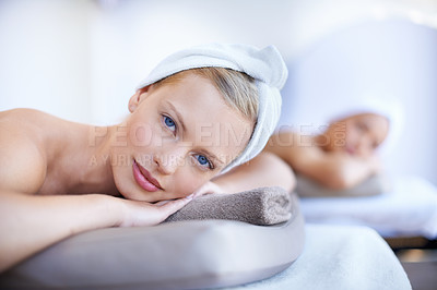 Buy stock photo Spa, portrait and women lying on table for skincare, beauty and luxury treatment for wellness. People, relax and face of calm person on bed in salon or hotel for massage or dermatology care for body