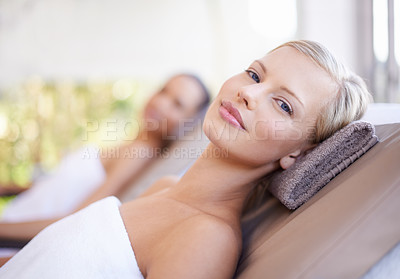 Buy stock photo A gorgeous blond woman looking at you while lying on a spa bed