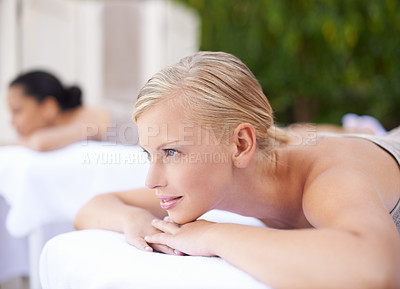 Buy stock photo Luxury, woman and relax on massage bed with smile for wellness, zen and beauty treatment for body care. Person, daydreaming and physical therapy at resort, salon table and spa on holiday or vacation