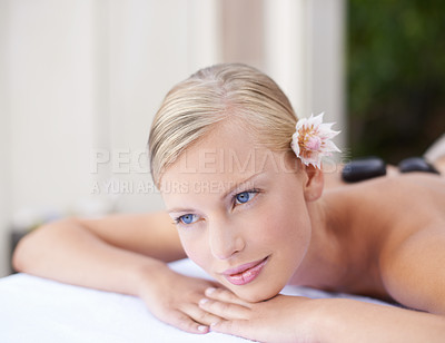 Buy stock photo Spa, woman and thinking on massage bed with relax for wellness, zen or beauty treatment for body care. Person, thoughtful and satisfaction at resort, salon table and luxury on holiday or vacation