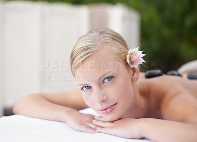 Buy stock photo Spa, woman and portrait on massage bed with relax for wellness, zen and beauty treatment for body care. Calm person, flower and stress relief at resort, table and peaceful on holiday or vacation