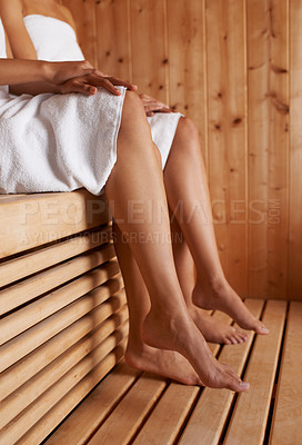 Buy stock photo Cropped image of two friends sitting in the sauna together