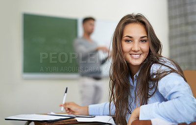 Buy stock photo Woman, portrait and writing or learning in classroom for education, language development or teaching knowledge. Face of happy student at her desk for high school, notebook and test notes with teacher