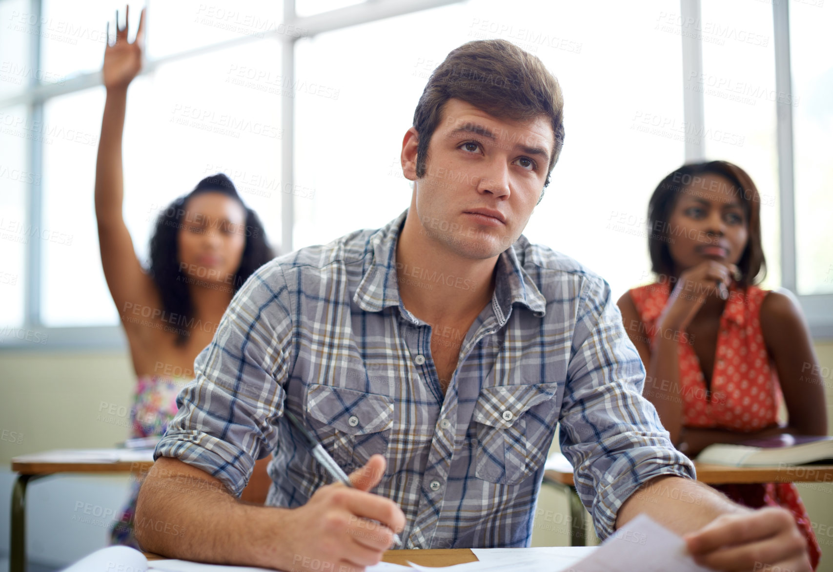 Buy stock photo Students, questions and learning in classroom for education, language development and knowledge in high school. Young people raise hands at desk for answer, quiz and test notes with information 