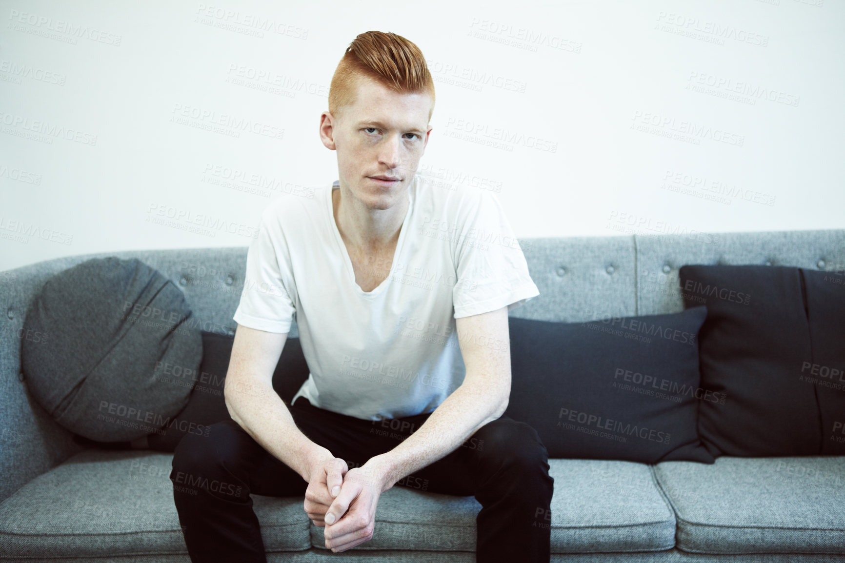 Buy stock photo A caucasian ginger sitting on a couch looking at the camera