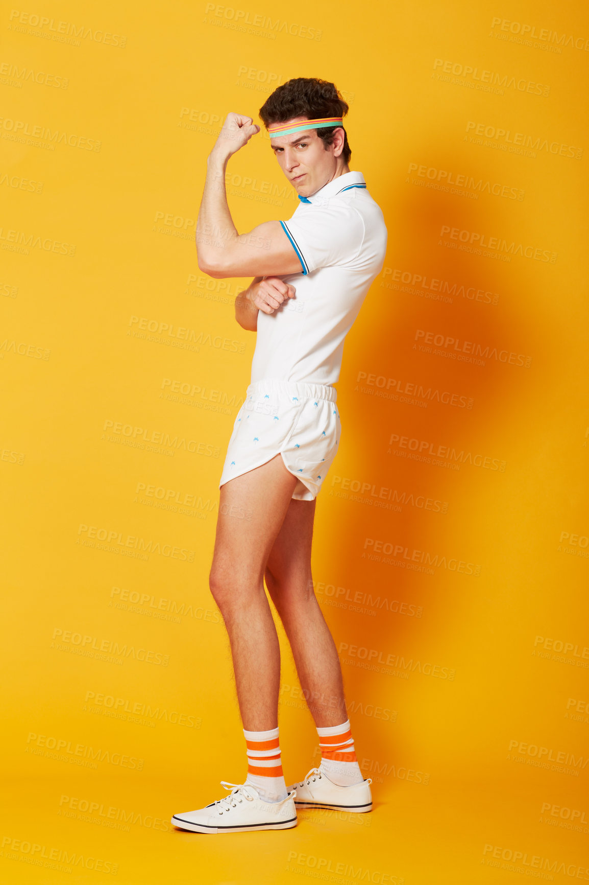 Buy stock photo Portrait, tennis and man flexing arms with fitness and workout on a yellow background. Person, model and athlete in sportswear and training with confidence and proud with wellness and healthy