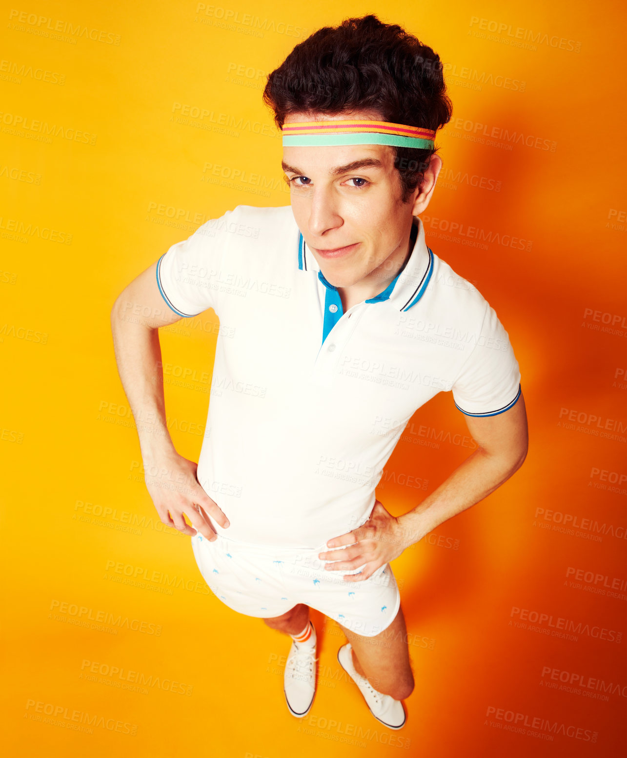 Buy stock photo Studio, portrait and man in retro tennis uniform with confidence, smile and high angle. Gym, club and happy athlete in vintage sports fashion on orange background with pride, game and sportswear.