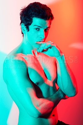 Buy stock photo Beauty, body and portrait of man in neon light studio for wellness, cosmetics or fitness inspiration on red background. Chest, face and muscular male model with fantasy aesthetic, glow or bodycare