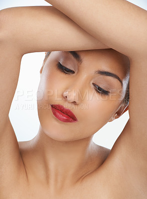 Buy stock photo Woman, face and beauty with red lipstick or makeup in cosmetics on a blue studio background. Closeup of young female person or model in relax or satisfaction for cosmetology or facial spa treatment