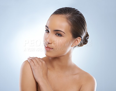 Buy stock photo Woman, face and skincare in natural beauty, makeup or cosmetics on a blue studio background. Young female person, brunette or model smile for smooth skin, glow or facial treatment on mockup space