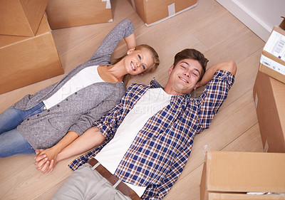 Buy stock photo Man, woman and portrait and floor with moving boxes or relax or real estate investing as new beginning, relocation or marriage. Couple, happy and rest bonding in apartment or rent, above or packing