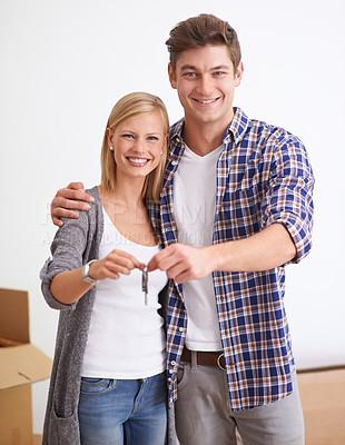 Buy stock photo A young couple holding the keys to their new apartment