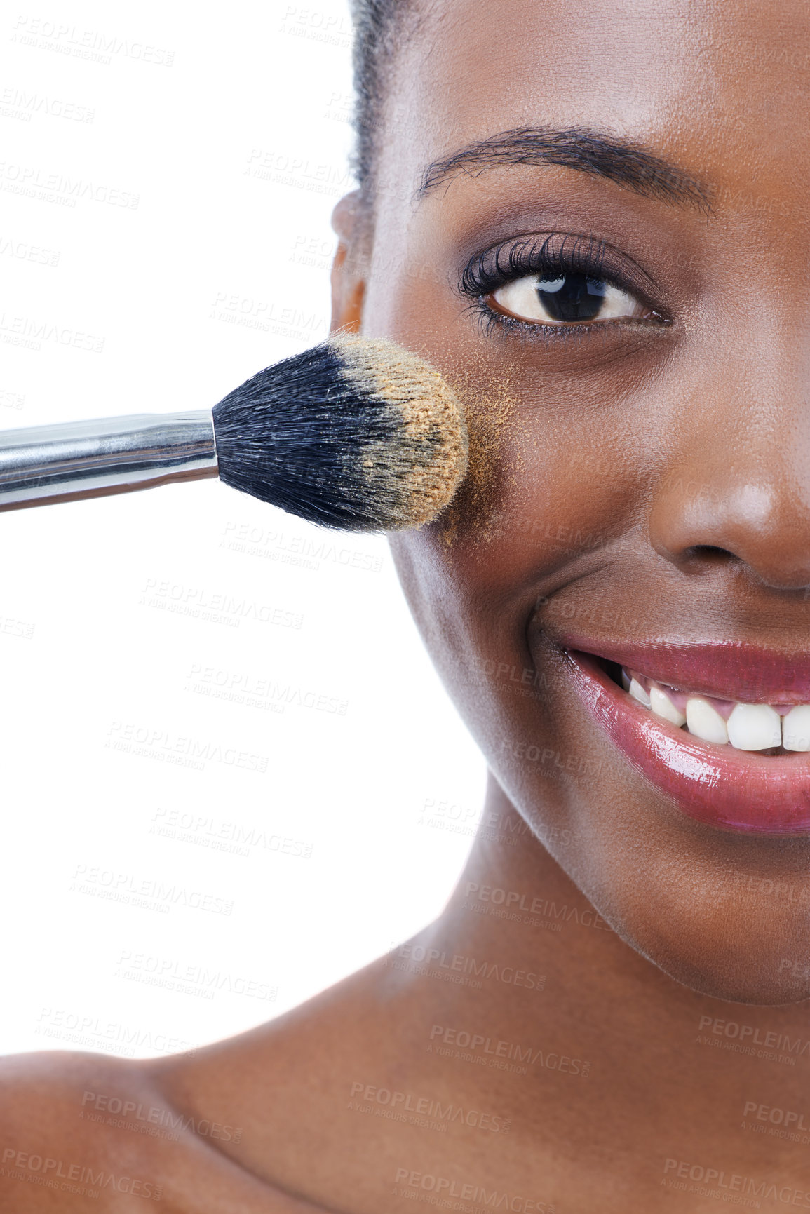 Buy stock photo Studio shot of a young african model applying foundation with a brush isolated on white