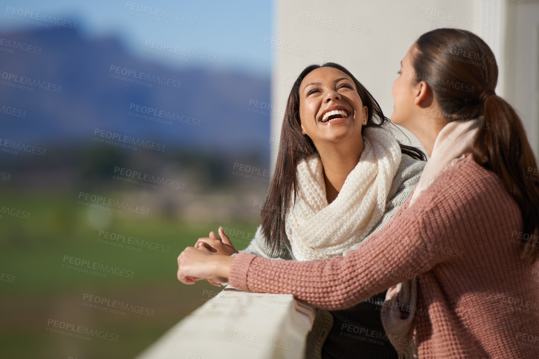 Buy stock photo Two lovely woman having a conversation on a balcony