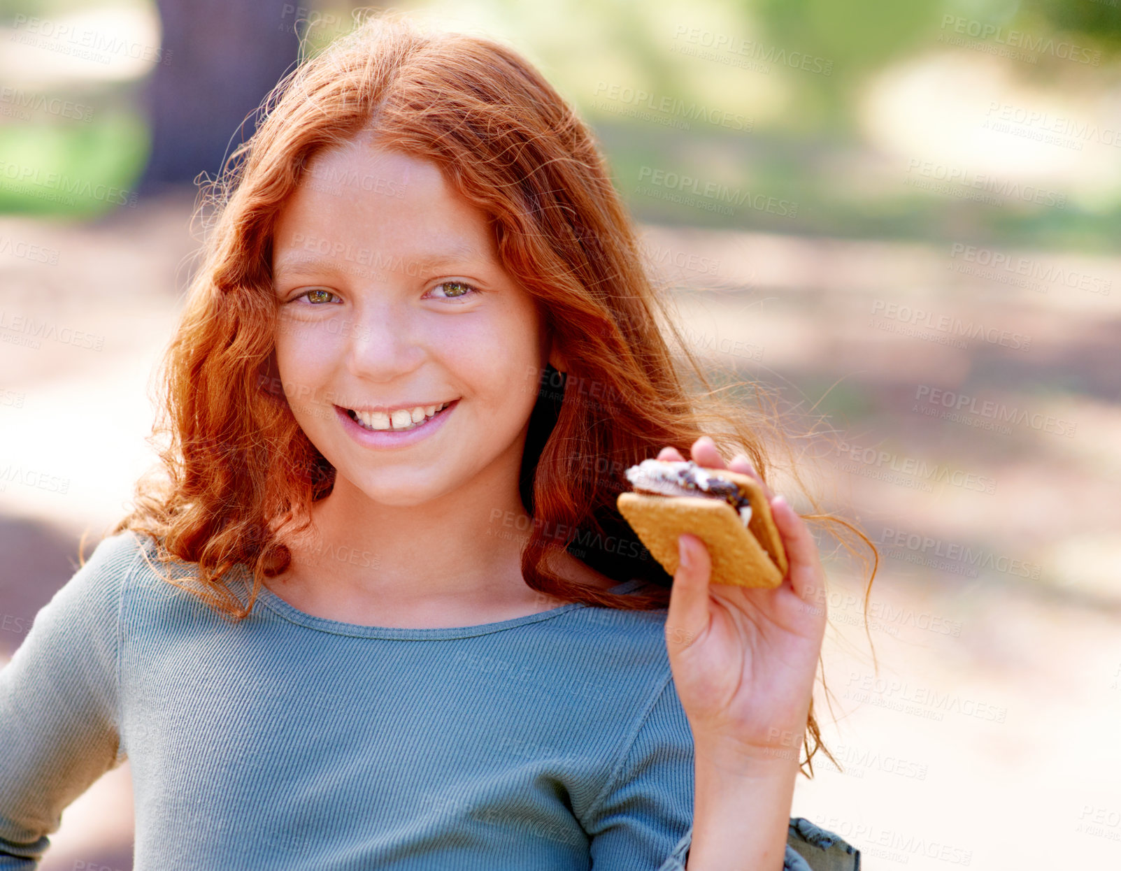 Buy stock photo Young girl, camping and smores in portrait in nature, happiness and hungry for sweet snack in woods. Red hair, child and happy face by sugar candy for eating, relax and outdoor on holiday adventure