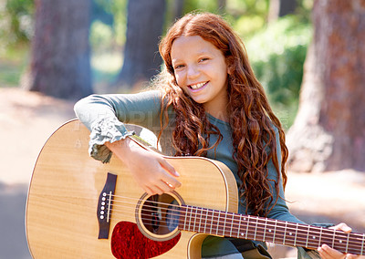 Buy stock photo Camp, portrait and girl child with guitar for entertainment, talent or music in woods or forest. Nature, musician and kid with acoustic string instrument outdoor in park or field on weekend trip.