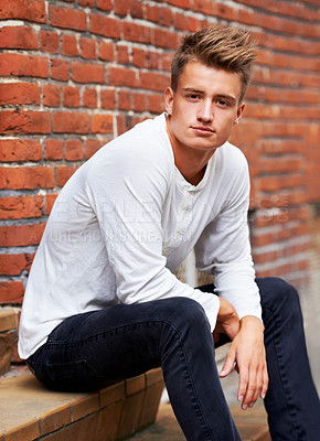 Buy stock photo Portrait of a handsome young man sitting outside