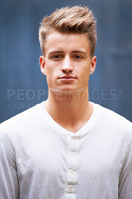 Buy stock photo Portrait, serious and young man with style on a wall background in the city. Relax, face and caucasian male person in a casual tshirt with trendy, cool fashion from New Zealand with confidence