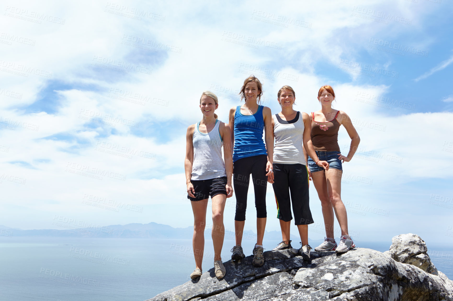 Buy stock photo Group of friends, portrait and adventure on a mountain for travel in nature. Happy female people together outdoor for sports challenge, hiking and exercise for fitness on a cliff with blue sky