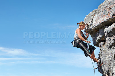 Buy stock photo Rock climbing, blue sky and freedom with woman on mountain cliff for adventure or travel with space. Strong, challenge and mockup with female climber training in nature for courage, safety or workout