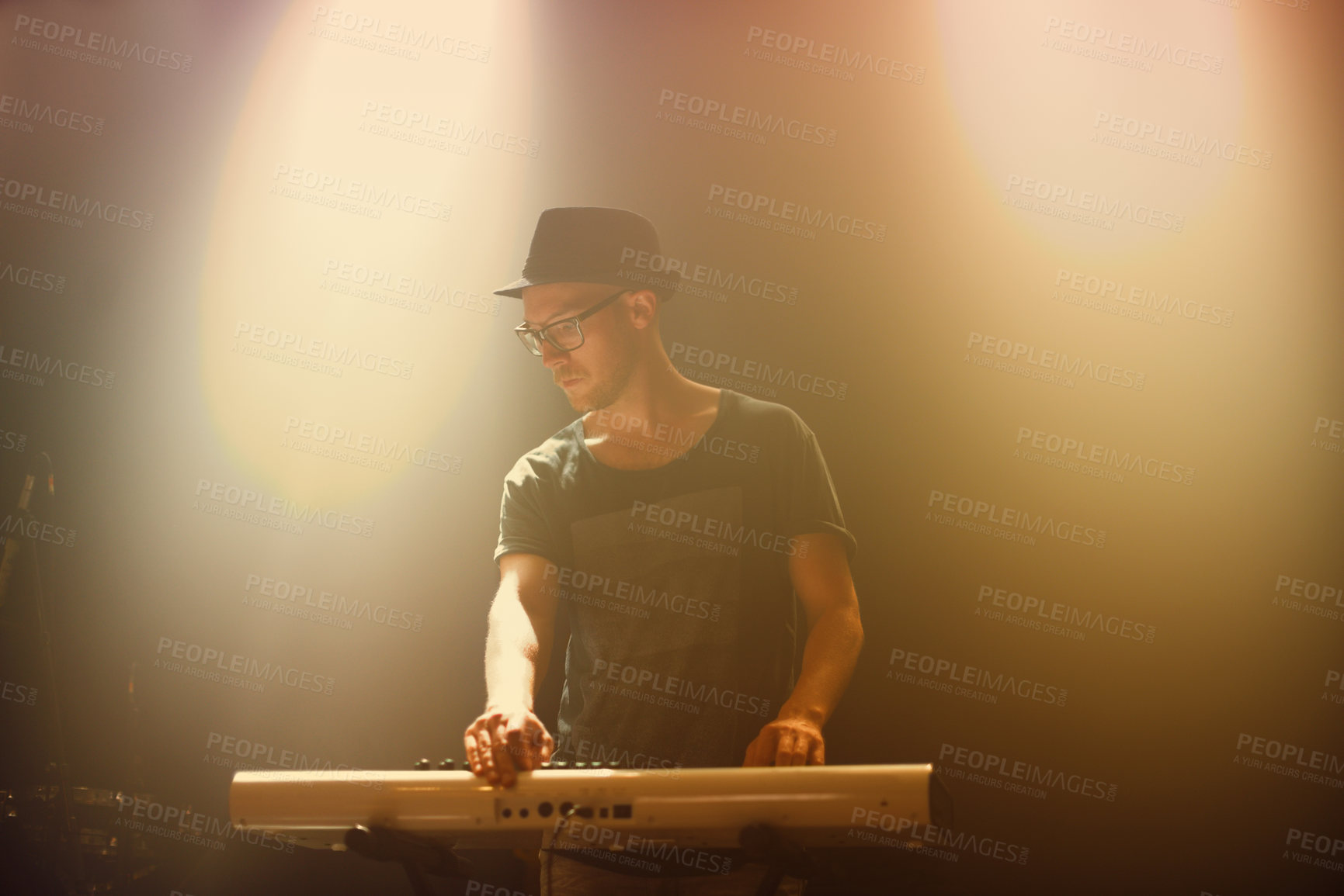 Buy stock photo Music, concert and man playing keyboard for performance at night with glasses in entertainment. Musician, artist and instrument for party and culture song at nightclub on new years eve at festival