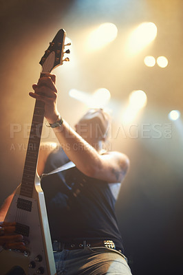 Buy stock photo A guitarist playing his heart out beneath the strobe lights. This concert was created for the sole purpose of this photo shoot, featuring 300 models and 3 live bands. All people in this shoot are model released.