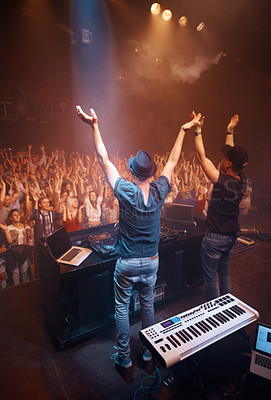 Buy stock photo Night, club and arms raised for dj at celebration with fans at stage for performance with piano and musician. Music festival, crowd and people with talent playing for audience in theater with energy