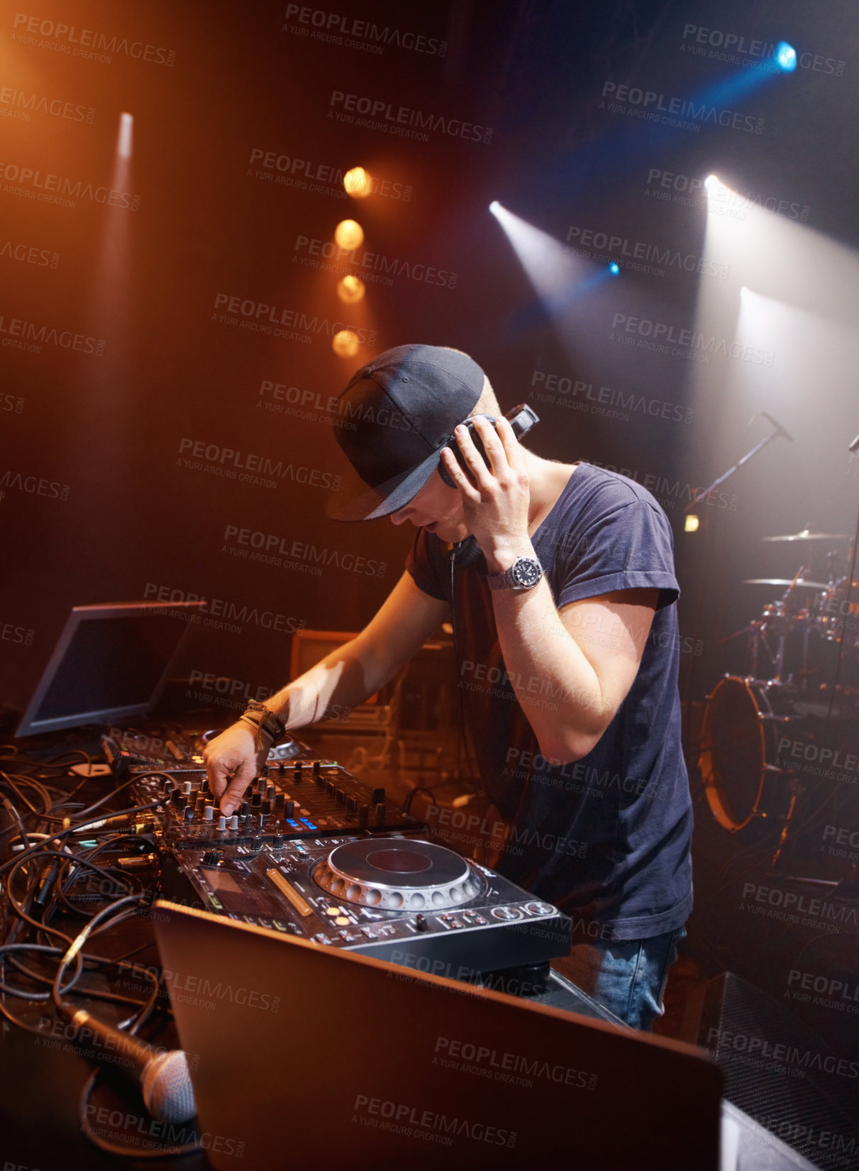 Buy stock photo DJ, headphones and audio on stage for sound check with turntables at concert in Australia. Male producer, mic and spotlights at club, party or festival for EP release, album or live music performance