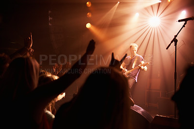 Buy stock photo Rear view of an excited crowd cheering their favourite band on beneath the strobe lights at a festival. This concert was created for the sole purpose of this photo shoot, featuring 300 models and 3 live bands. All people in this shoot are model released.
