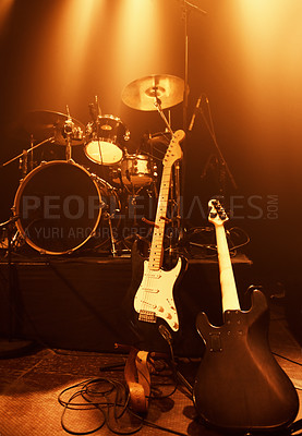 Buy stock photo Instruments, guitar and drums for band at stage for concert and performance of music with talent. Electric, equipment and creativity in theater with spotlight for show at night with no people