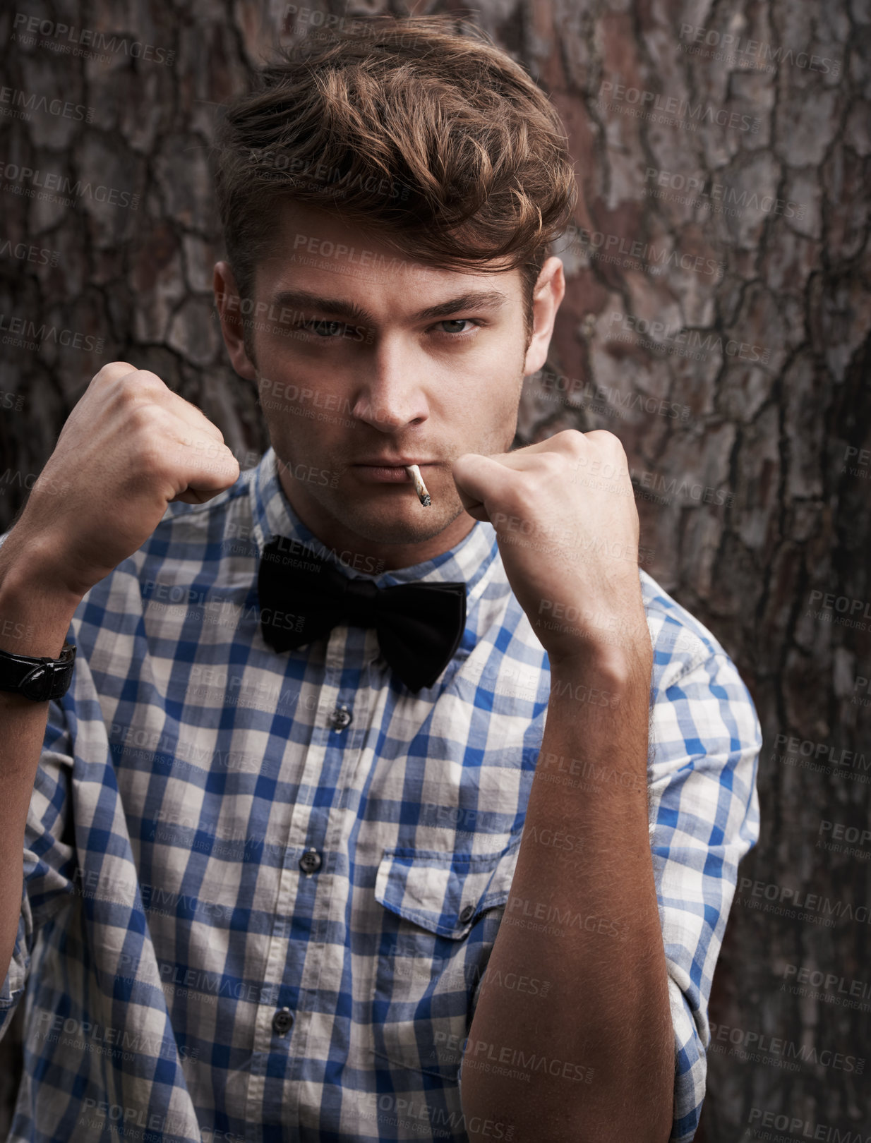 Buy stock photo Fight, smoking and portrait of man in outdoors for challenge, strong and boxing. Cigarette, hipster and anger with face of male person and hands up in nature for combat, cool and trendy style 