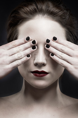 Buy stock photo A beautiful pale woman with dark lipstick covering her eyes