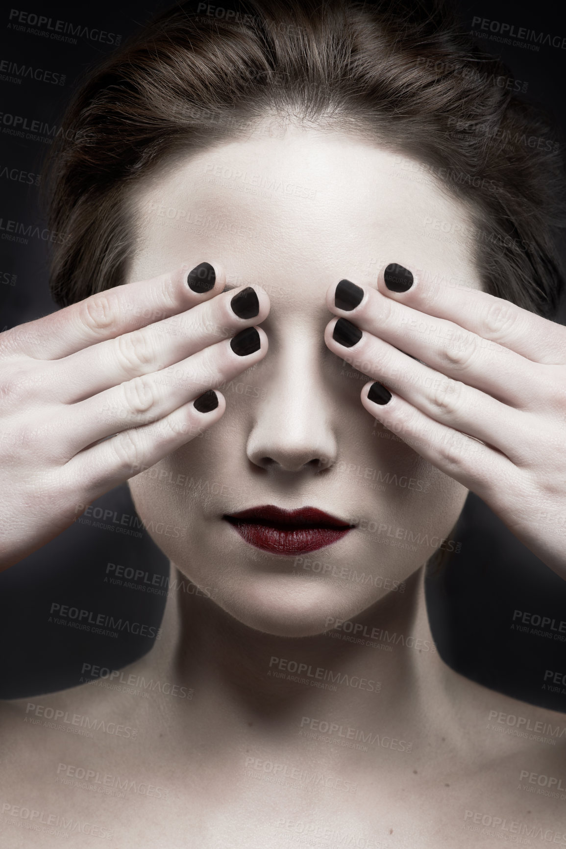 Buy stock photo A beautiful pale woman with dark lipstick covering her eyes