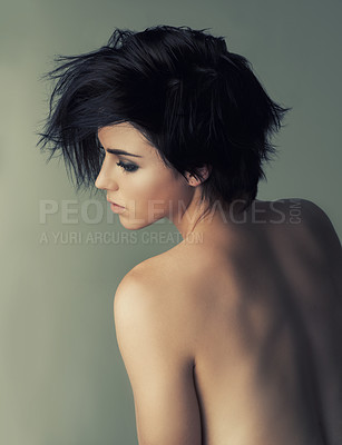 Buy stock photo Rearview studio shot of an attractive woman looking over her bare shoulder