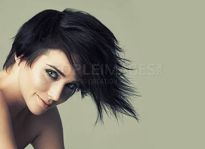 Buy stock photo A funky young woman with an alternative hairstyle posing in studio