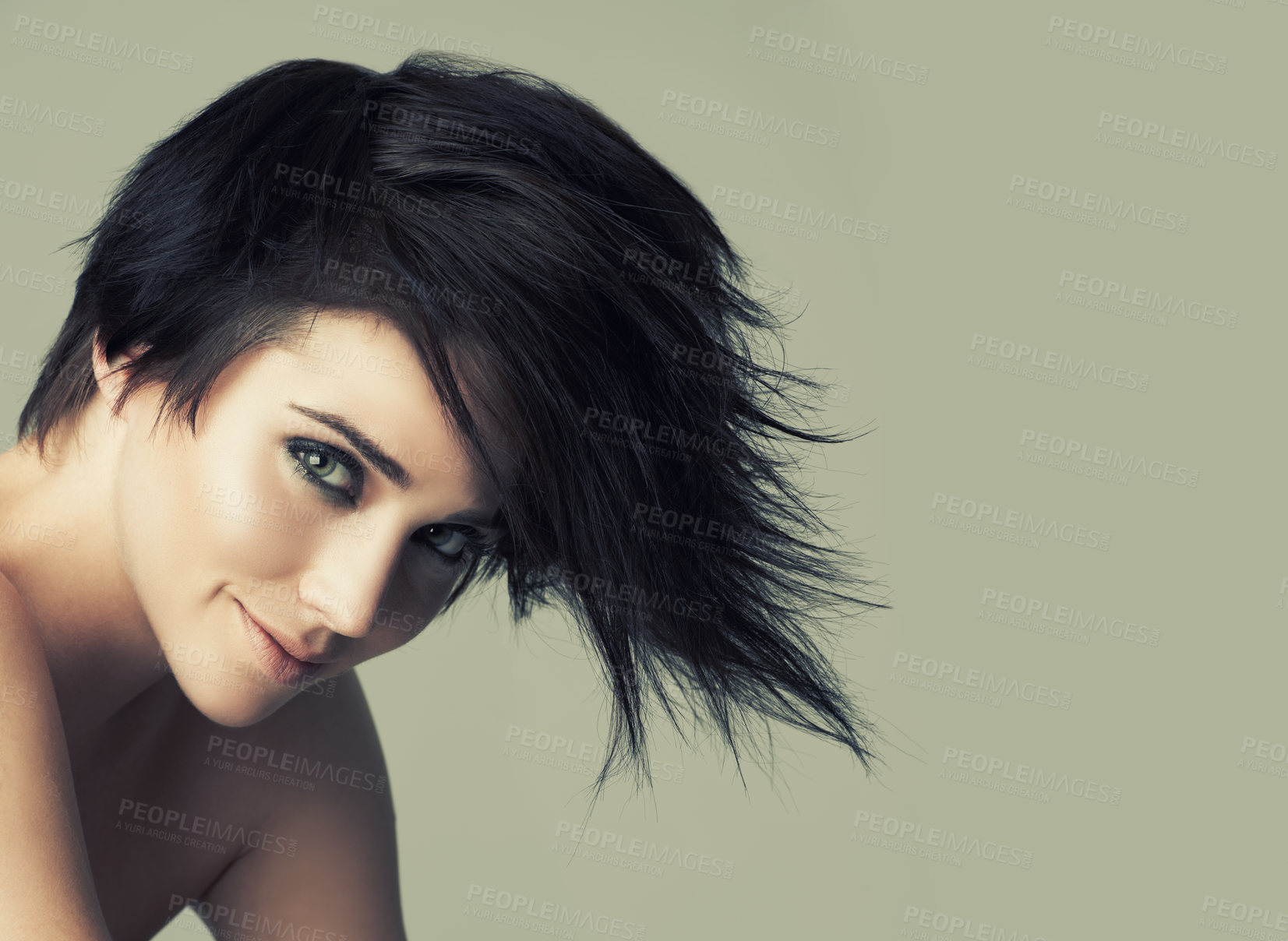 Buy stock photo A funky young woman with an alternative hairstyle posing in studio