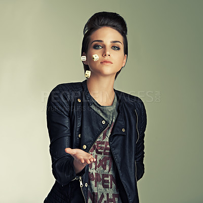 Buy stock photo A gorgeous punk tossing dice into the air in a studio shoot