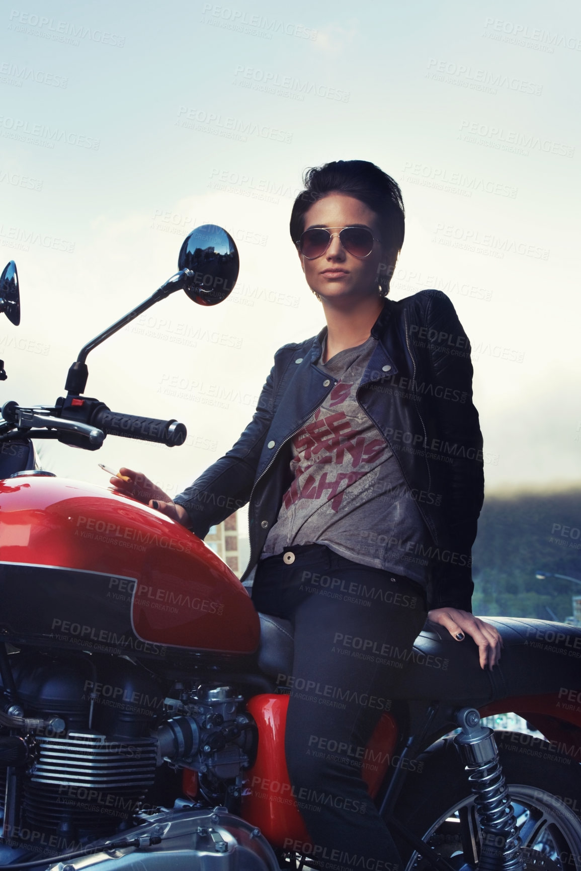 Buy stock photo Motorcycle, leather and rebel woman in city with sunglasses for travel, transport or road trip. Fashion, evening and person with attitude on classic or vintage bike for transportation or journey