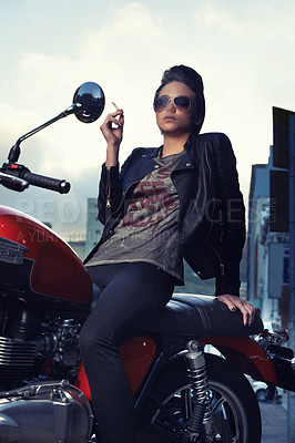 Buy stock photo Motorcycle, cigarette and woman smoking in city for travel, transport or road trip as rebel. Fashion, tobacco or nicotine and biker with attitude on classic or vintage bike for urban journey