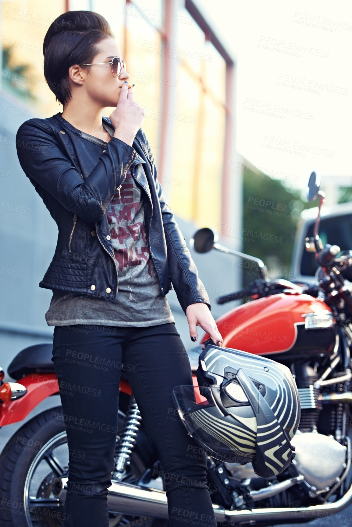 Buy stock photo Woman, city and motorcycle while smoking on a break from her journey or commute in italy. Punk style, tobacco and woman with a nicotine cigarette in Milan on motorbike with urban and edgy fashion