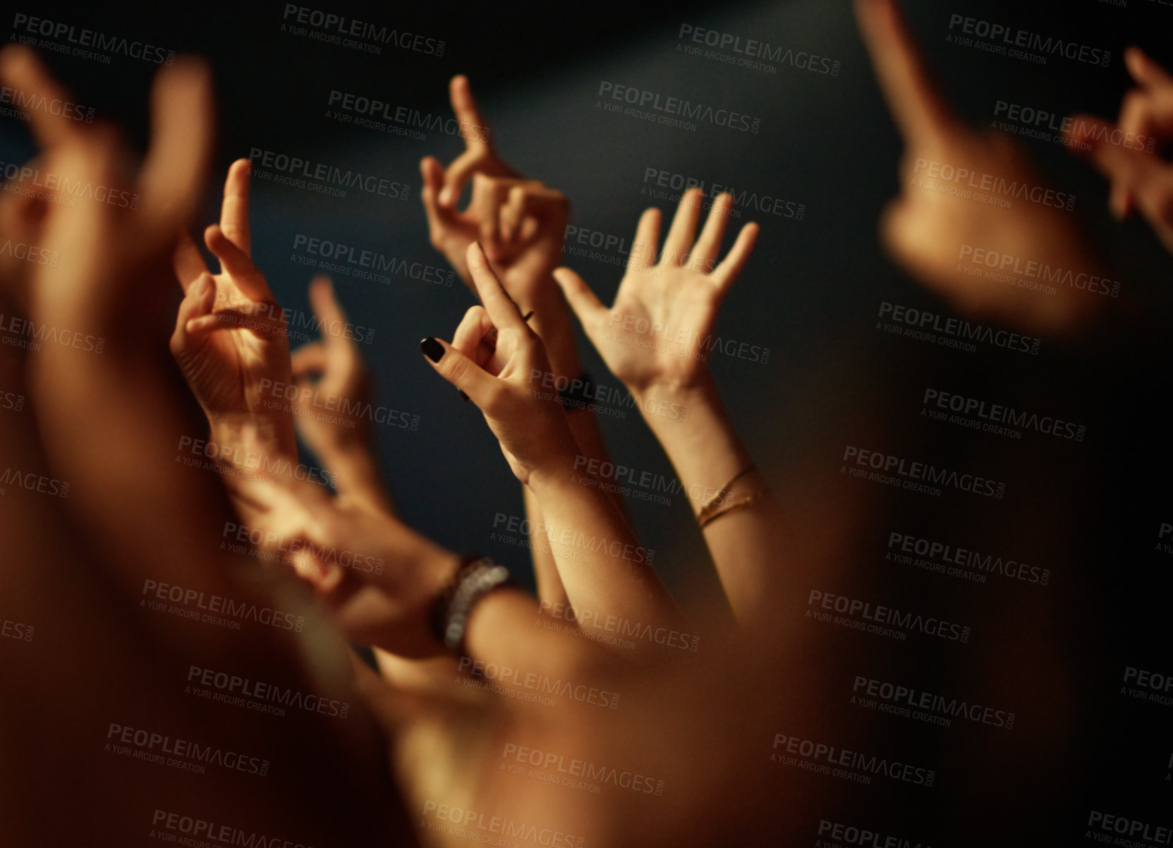 Buy stock photo A crowd of people raising their arms to the music