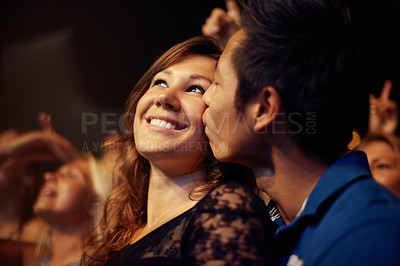 Buy stock photo A young couple kissing at a rock concert. This concert was created for the sole purpose of this photo shoot, featuring 300 models and 3 live bands. All people in this shoot are model released.