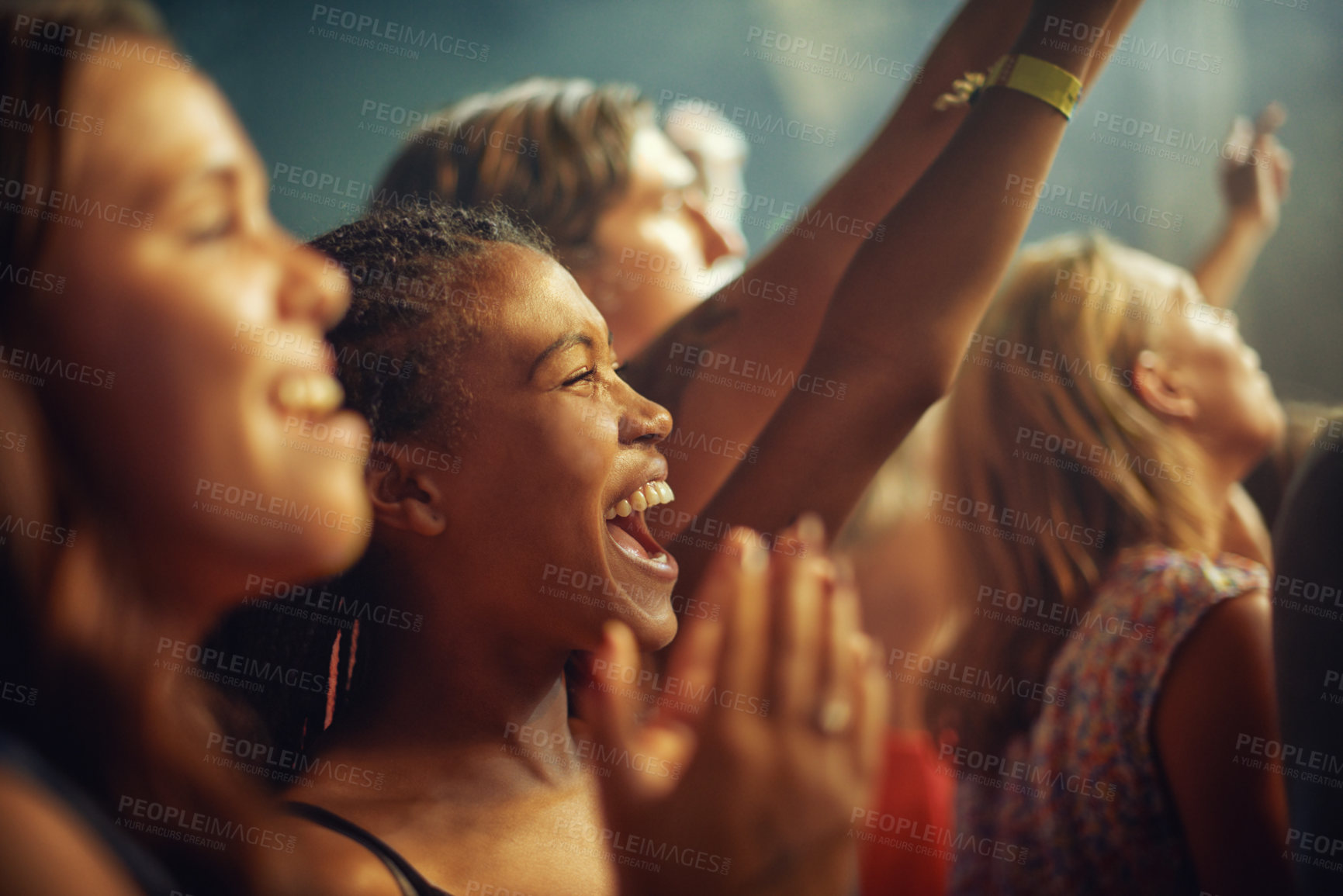 Buy stock photo Young girls in an audience enjoying their favourite band's performance