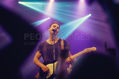 Buy stock photo Musician playing guitar and singing at a gig