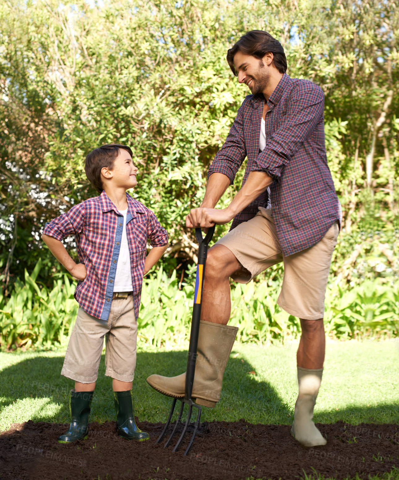 Buy stock photo Child, father and smile with gardening in nature using tools for agriculture help and ecology education. Soil, bonding and a man teaching boy kid to plant with fork for organic earth growth