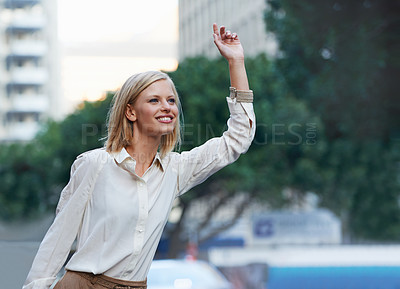 Buy stock photo A gorgeous woman hailing a cab after a long day of clothes shopping